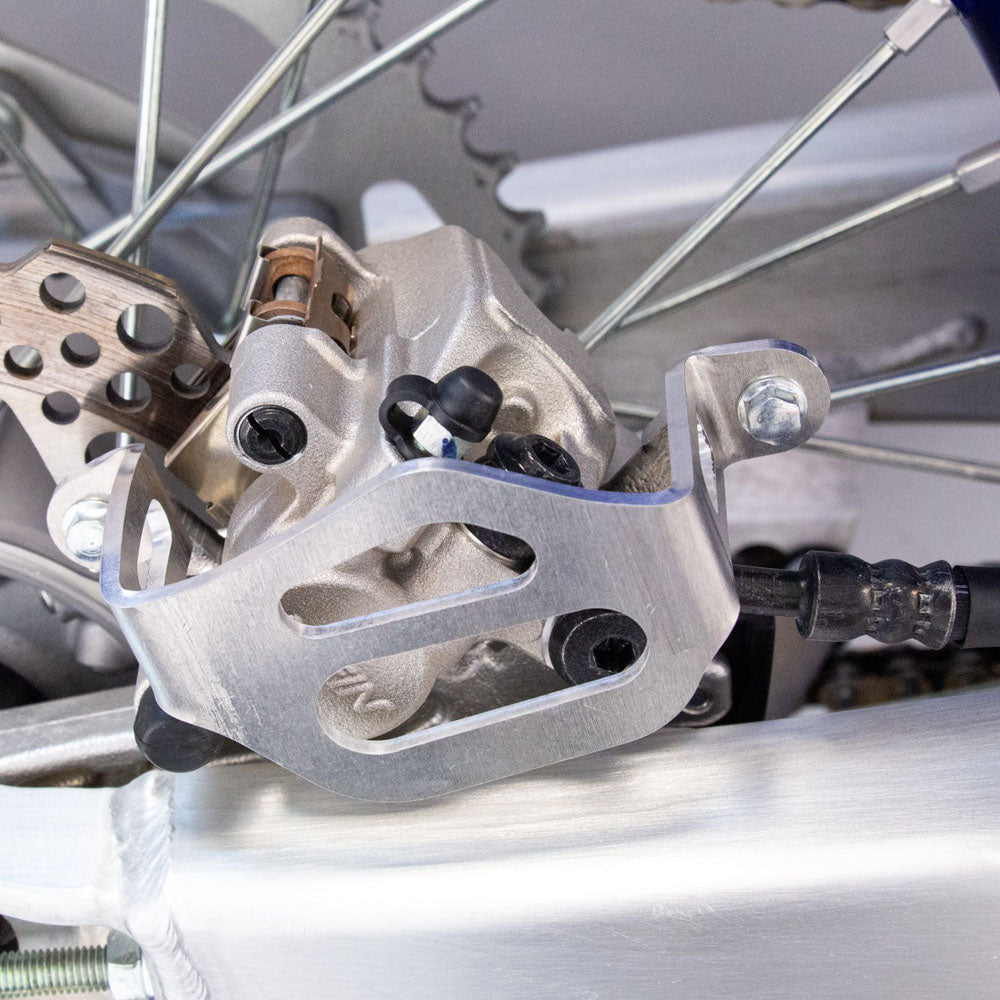 WORKS CONNECTION REAR BRAKE CALIPER GUARD YAMAHA YZ125/250 22-25, YZ125/250X 23-25, YZ250F 21-25, YZ250FX 22-25, YZ450F 20-25, YZ450FX 21-25